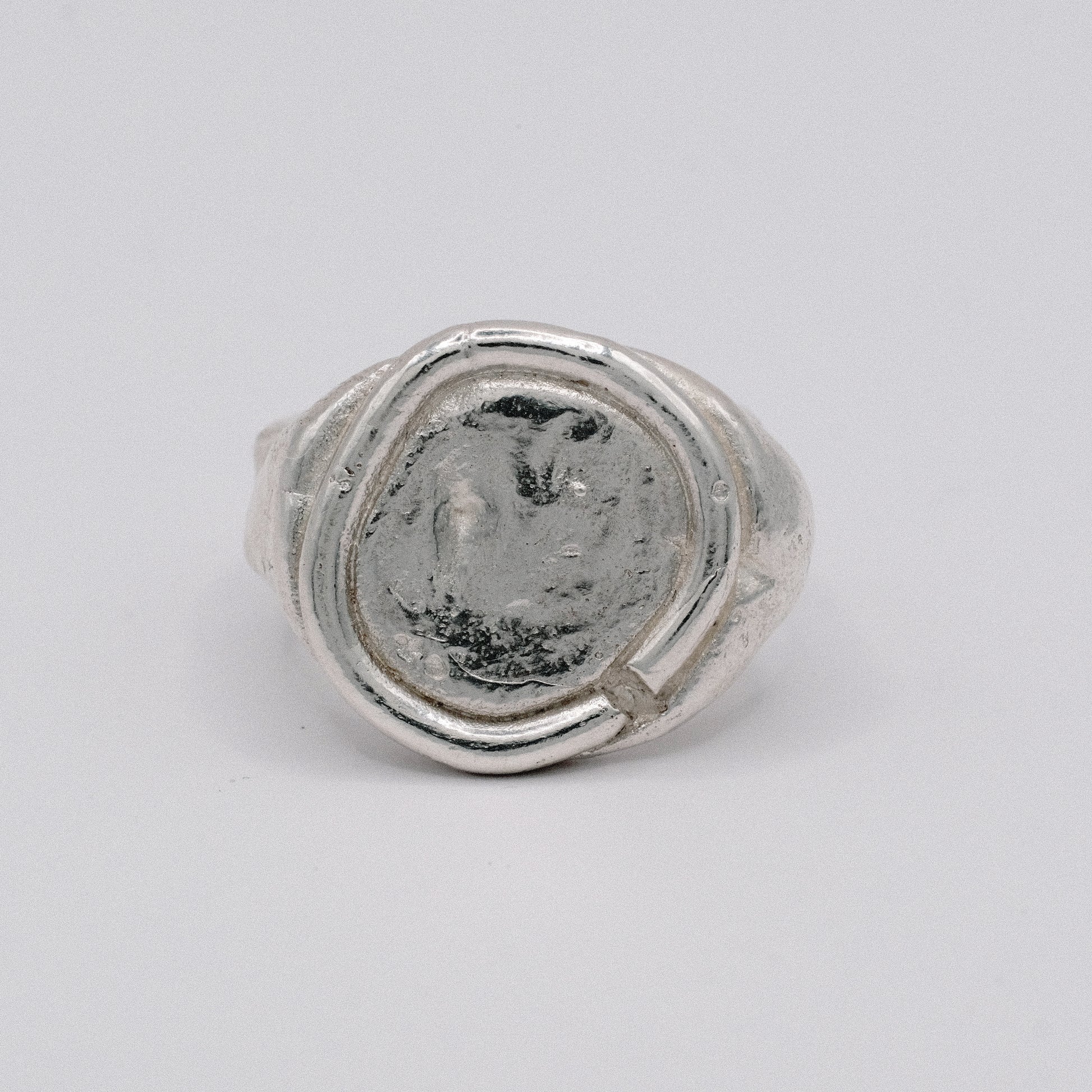 Silver ARTE ring with a textured surface resembling an ancient coin