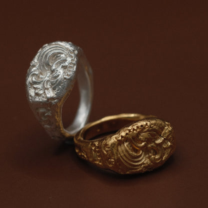Gold and silver atlantis rings with intricate designs 