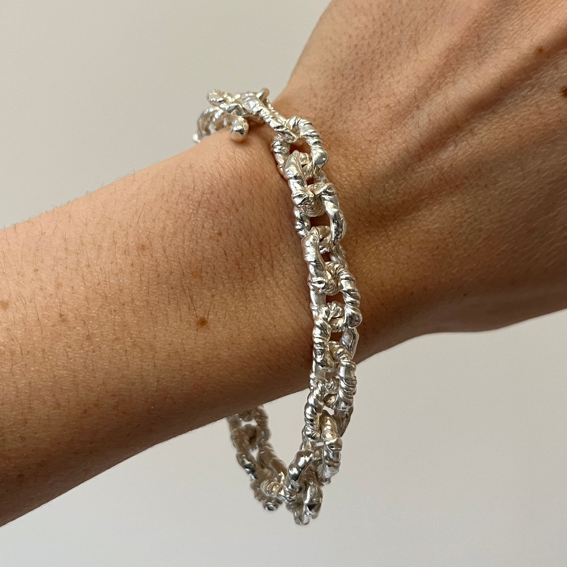 Silver elegant VELA chain bracelet on a wrist 