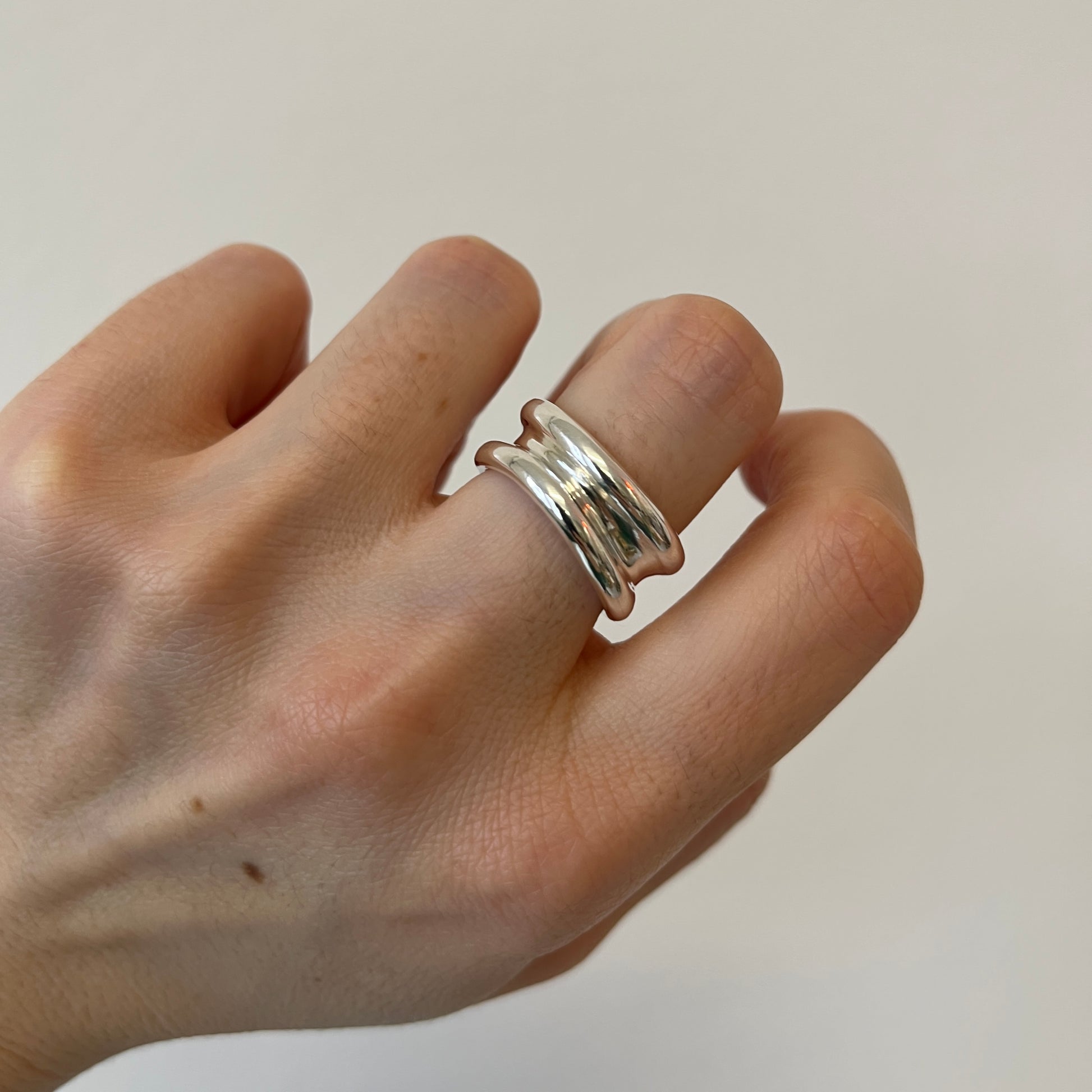 Silver organic minimalist YUNA ring on finger 